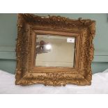 Wall mirror in ornate gilt frame