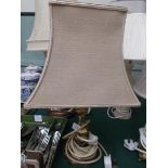 Brass based table lamp with light brown parchment shade