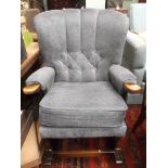 Oak framed fireside arm/rocking chair the high backed arms and loose seat upholstered in