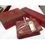 3 almost matching dressing table boxes the exterior of each in crimson satin cloth with raised