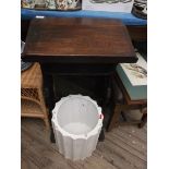 Low oak lectern and a heavy white waste bin