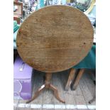 Oak circular tilt topped side table on tricorn base (top 22" diam.