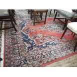 Maroon and blue ground tasselled carpet with diamond to the central field and floral patterned