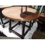 Circular copper topped coffee/drinks table on 4 splayed turned feet each united by horizontal