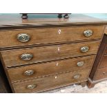 Georgian Oak chest of 4 long graduated drawers each with oval brass finger plates and drop handles