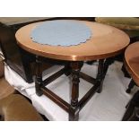 Circular copper topped coffee/drinks table on 4 turned splayed feet each united by horizontal