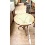 Circular cane topped side table on 3 splayed feet