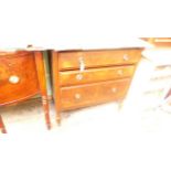 Chest of three drawers on turned feet with circular finger plates and drop handles