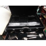 Unused two tier set of stainless steel cutlery in black leather carry canteen
