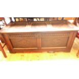 Antique oak coffer chest with three panels to top and carved freeze and double panels to front