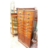 Oak filing cabinet fitted sixteen pullout drawers and two storage cabinets below (27"w x 61"h)