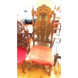 Most unusual heavily carved high backed chair on four bold feet united by shaped stretcher,