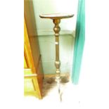 Gold painted plant pedestal with circular top on tricorn base