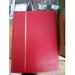 Red stamp album containing stamps of Canada,