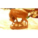 Carved wooden ornament of a cow suckling her calf