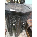 Oriental octagonal topped heavily carved side table with bone inlay