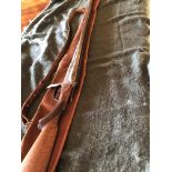 Ancient 12 bore side by side Roberts shotgun with brown canvas sleeve