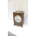 Unusual carriage clock in decorative brass case,