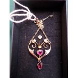 Art nouveau gold pendant on chain inset ruby stone and three stud pearls