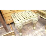 Ornate brass trivet seat on claw feet the top with multi four leaf clover insets
