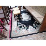 Black ground multi coloured carpet in similar style (5'9 x 9')