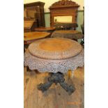 Larger and most decorative circular topped table with intricate beaded and foliate carving to top,