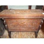 Rectangular topped carved oak stool, the fold over top revealing storage area,