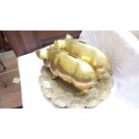 Pair of brass pig money boxes on two ornate brass trays