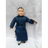 Oriental pot headed doll dressed in traditional dark blue costume