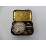 A Michelin tyre pressure gauge in original tin.