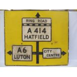 Three cast aluminium road signs on their original yellow backboard with arrows, a rare sign to