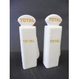 A pair of salt and pepper pots in the shape of petrol pumps with globes bearing 'Total' branding.