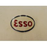 An Esso oval cap badge.