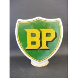 A BP shield shaped glass petrol pump globe, one side badly damaged and faded.