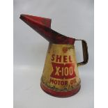 A Shell X-100 Motor Oil 1/2 gallon measure.