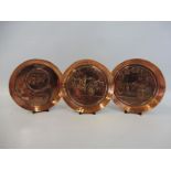 Three differently designed Daimler advertising copper ashtrays, one depicting King George/Queen Mary