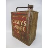 An unusual two gallon petrol can marked 'Property of Casey's Garage Cork' to one side.