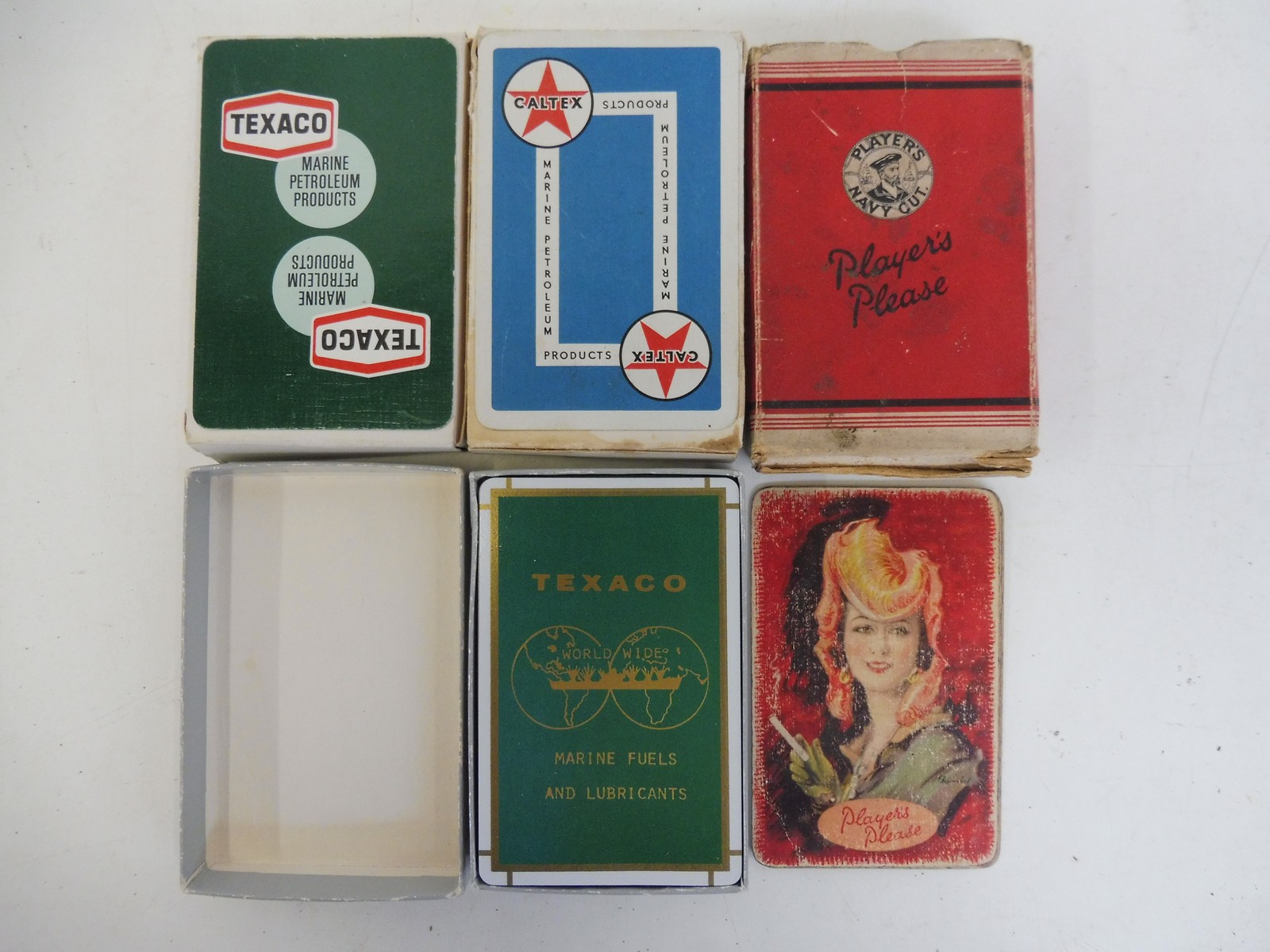 Four sets of complete playing cards including Texaco Marine fuel cards, Caltex etc.