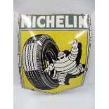 A Michelin pictorial enamel sign depicting Mr. Bibendum rolling a tyre, 24 x 32".