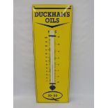 A Duckham's Oils enamel thermometer in near mint condition, 12 x 36".