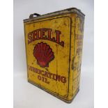 A Shell Lubricating Oil rectangular gallon can.