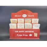 An Esso Road Map rack with assorted maps inside.