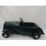 An unusual pedal car in the form of a pre-war car.