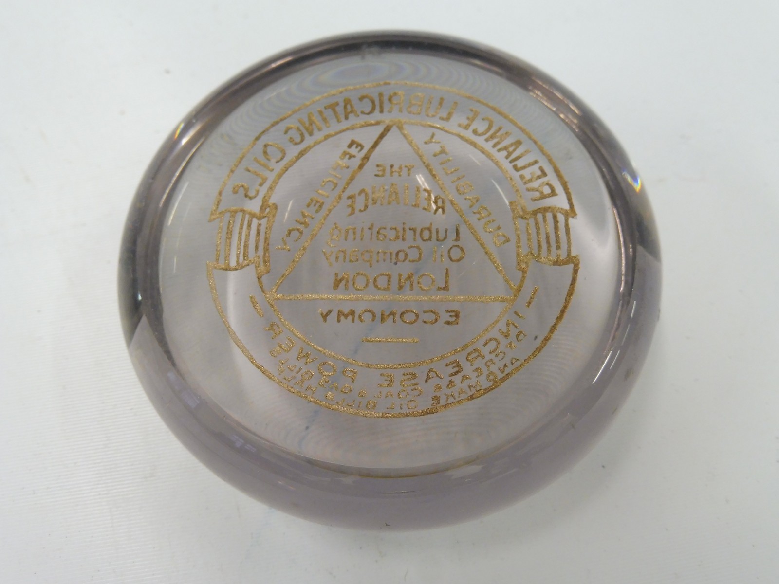 A Reliance Lubricating Oil Company of London glass paperweight. - Image 2 of 2