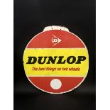 A Dunlop circular hardboard advertisement, 23 1/2" diameter.