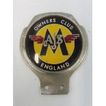 An AJS/Matchless Owners Club badge.