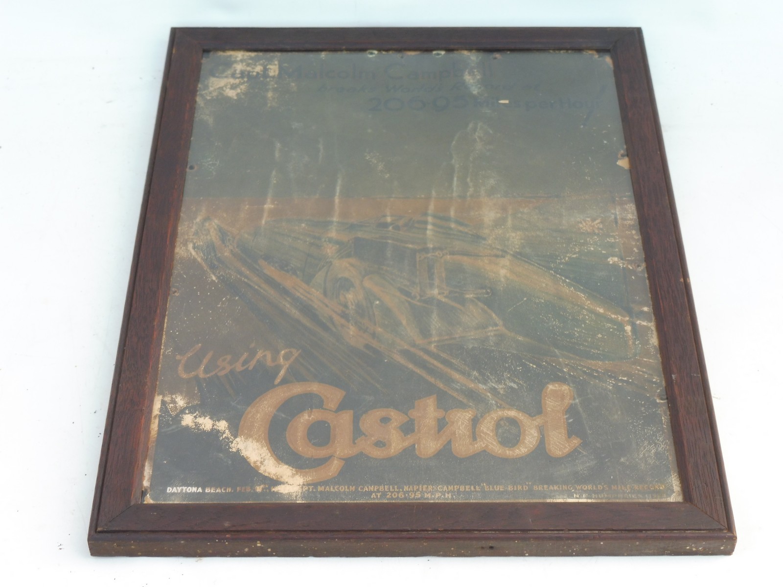 An early Castrol pictorial showcard depicting Sir Malcolm Campbell in Bluebird at speed, set