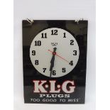 A reproduction K.L.G. Plugs showroom clock, with battery powered movement, 10 1/2 x 14".