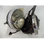 A 1950s motorcycle headlamp, appears complete plus an additional shell.