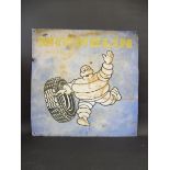 A Michelin pictorial tin advertising sign, depicting Mr. Bibendum rolling a tyre, 29 1/2 x 29 1/2".